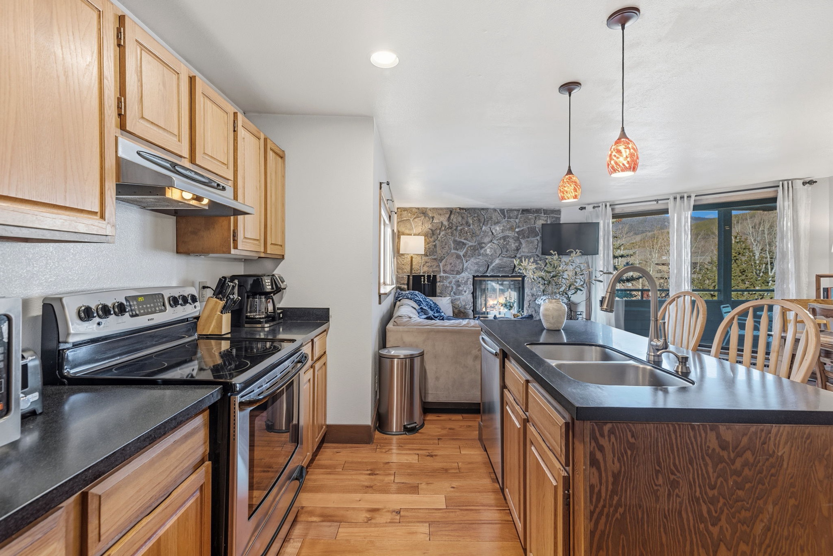 Full kitchen opening toward the fireside living room